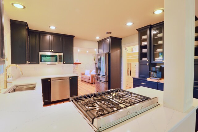 120 Hickory Ln, Lancaster, OH 43130 - kitchen featuring stainless steel appliances, recessed lighting, glass insert cabinets, and light stone counters