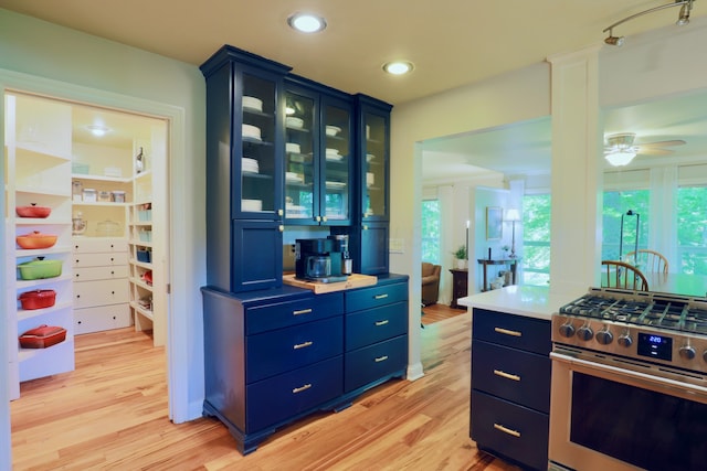 120 Hickory Ln, Lancaster, OH 43130 - kitchen with gas range, blue cabinetry, a ceiling fan, light wood finished floors, and recessed lighting