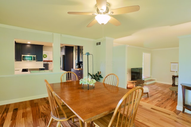 120 Hickory Ln, Lancaster, OH 43130 - dining area featuring crown molding, light wood-type flooring, and a ceiling fan