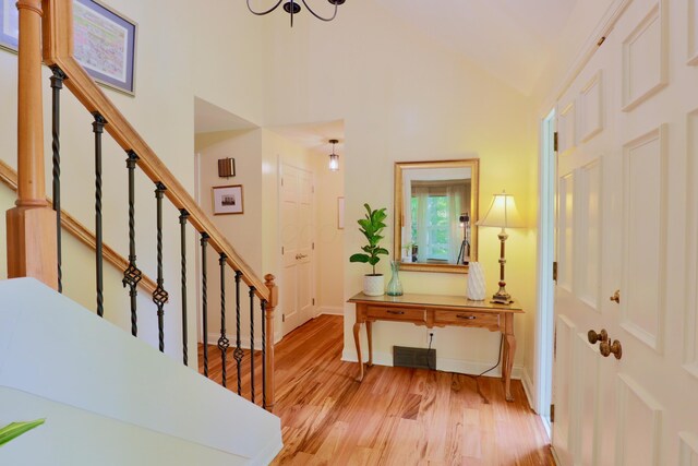120 Hickory Ln, Lancaster, OH 43130 - foyer entrance with light wood-style flooring, stairway, high vaulted ceiling, and a chandelier