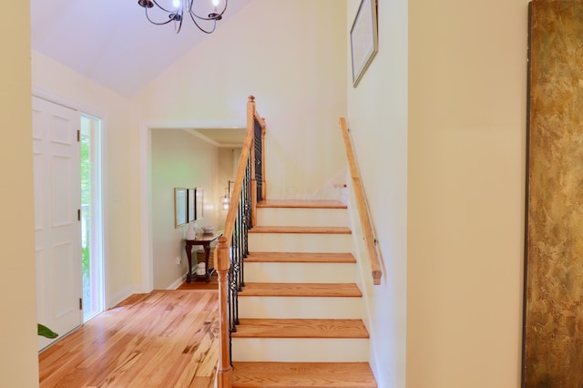 120 Hickory Ln, Lancaster, OH 43130 - stairs featuring wood finished floors, a chandelier, and high vaulted ceiling