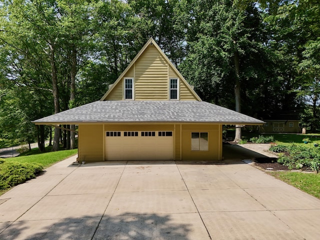 120 Hickory Ln, Lancaster, OH 43130 - garage featuring driveway and view of scattered trees