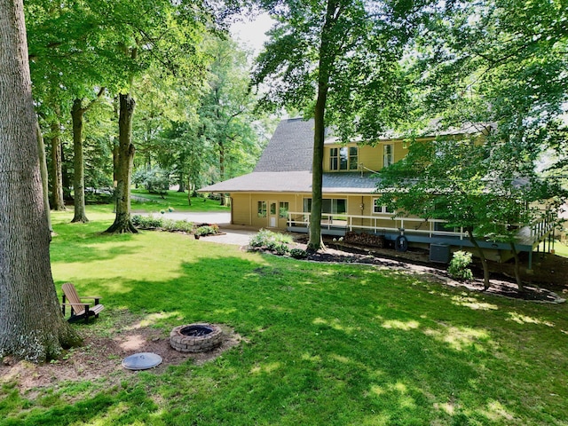120 Hickory Ln, Lancaster, OH 43130 - view of grassy yard featuring an outdoor fire pit and a patio