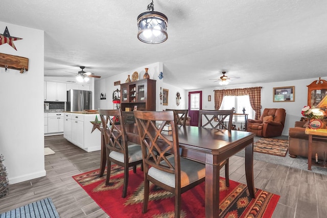 562 Bowman Ln, Chillicothe, OH 45601 - dining room featuring a ceiling fan, a textured ceiling, and light wood-style floors