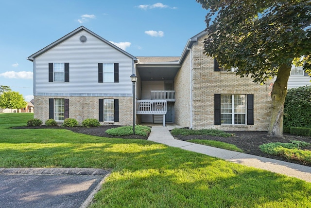 2082 Park Run Dr Unit A, Columbus, OH 43220 - townhome / multi-family property featuring brick siding, a front lawn, and a balcony