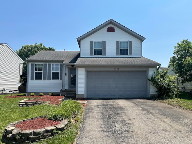 8465 Squad Dr, Galloway, OH 43119 - traditional-style home with an attached garage, driveway, and a shingled roof