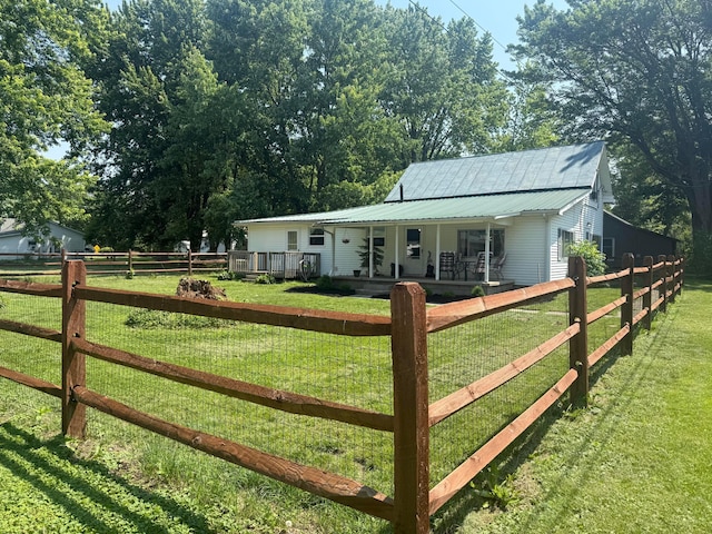 247 3rd St, La Rue, OH 43332 - view of front of home with a porch, a fenced front yard, and a metal roof