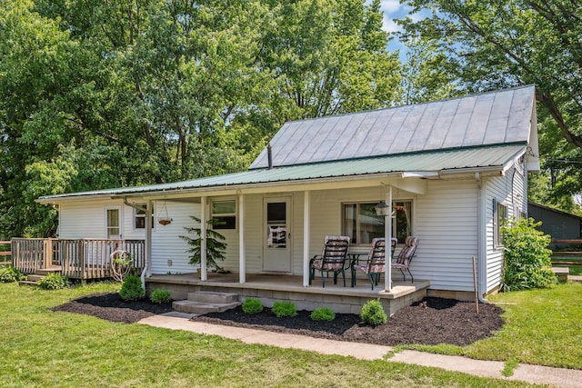 247 3rd St, La Rue, OH 43332 - view of front of house featuring covered porch, a front yard, and a metal roof