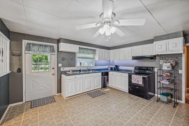 247 3rd St, La Rue, OH 43332 - kitchen featuring black range with electric cooktop, under cabinet range hood, healthy amount of natural light, white cabinets, and a paneled ceiling