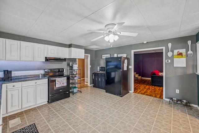 247 3rd St, La Rue, OH 43332 - kitchen with black appliances, under cabinet range hood, ceiling fan, white cabinetry, and a drop ceiling
