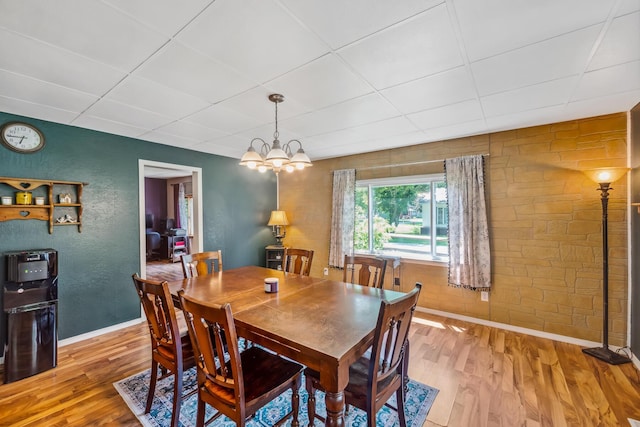 247 3rd St, La Rue, OH 43332 - dining area featuring wood finished floors, a chandelier, a paneled ceiling, and a textured wall