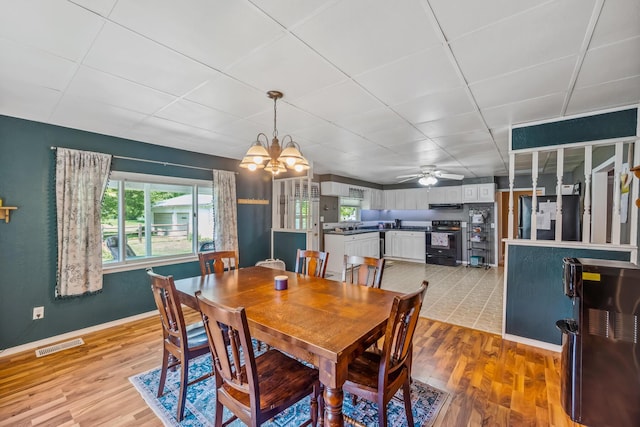 247 3rd St, La Rue, OH 43332 - dining area with healthy amount of natural light, light wood-type flooring, a chandelier, and a drop ceiling
