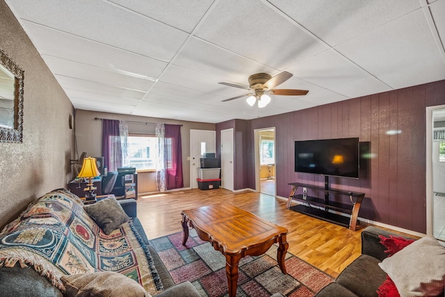 247 3rd St, La Rue, OH 43332 - living room with wood finished floors, healthy amount of natural light, ceiling fan, and wood walls