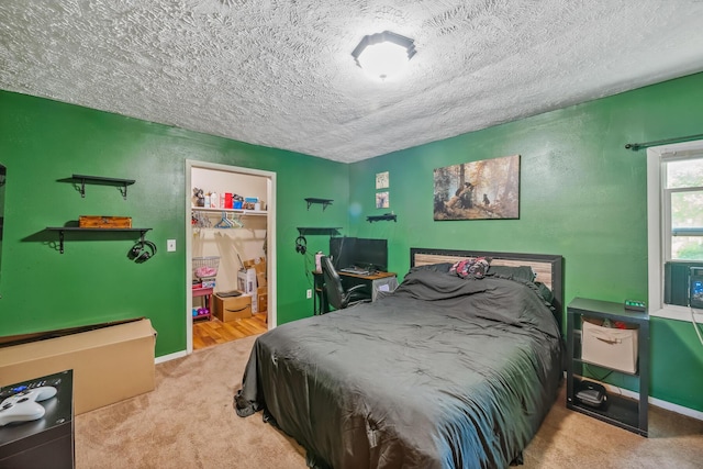 247 3rd St, La Rue, OH 43332 - carpeted bedroom featuring a textured ceiling, a walk in closet, and a closet