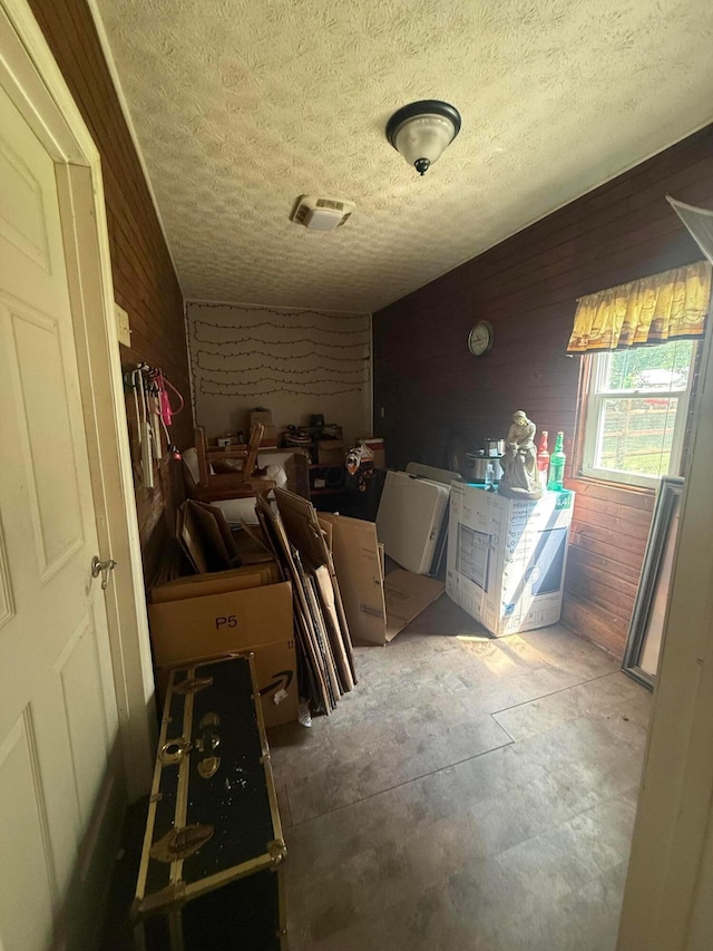 247 3rd St, La Rue, OH 43332 - interior space with wooden walls, a textured ceiling, and unfinished concrete flooring