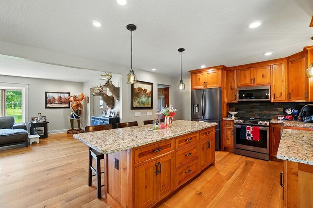 8384 Morris Rd, Hilliard, OH 43026 - kitchen with stainless steel appliances, light wood-type flooring, brown cabinetry, and recessed lighting