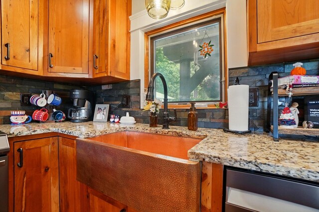 8384 Morris Rd, Hilliard, OH 43026 - kitchen with decorative backsplash, brown cabinets, and light stone countertops