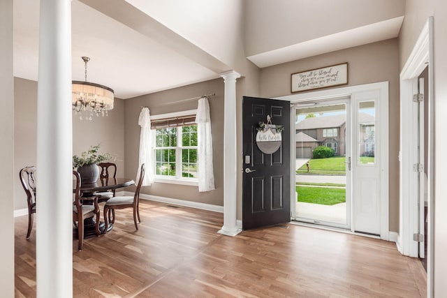 2467 Roe Dr, Lewis Center, OH 43035 - entryway with wood finished floors, ornate columns, and a chandelier