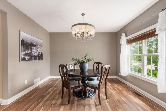 2467 Roe Dr, Lewis Center, OH 43035 - dining area featuring wood finished floors and a chandelier