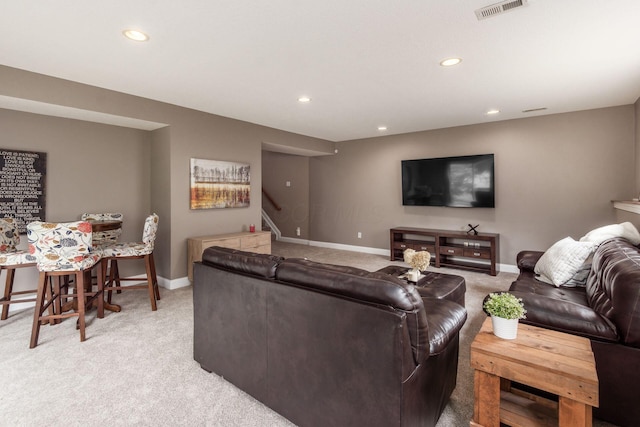 2467 Roe Dr, Lewis Center, OH 43035 - living area featuring light colored carpet, stairs, and recessed lighting