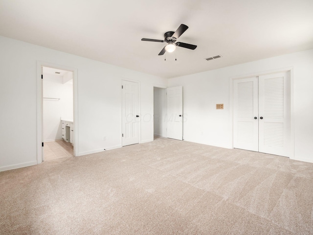 6509 Evening St, Worthington, OH 43085 - unfurnished bedroom featuring light carpet, ensuite bath, and ceiling fan