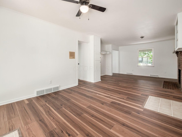 6509 Evening St, Worthington, OH 43085 - unfurnished living room featuring ceiling fan, wood finished floors, and a brick fireplace