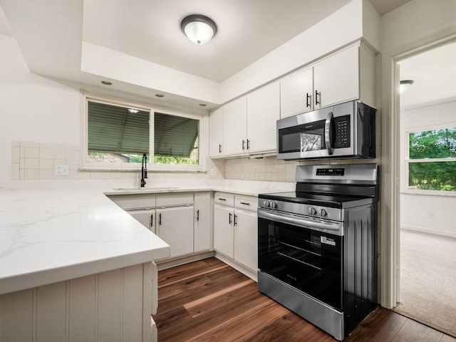 6509 Evening St, Worthington, OH 43085 - kitchen with stainless steel appliances, backsplash, white cabinets, and dark wood-style floors