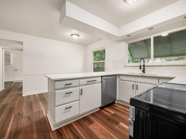 6509 Evening St, Worthington, OH 43085 - kitchen with stainless steel dishwasher, dark wood finished floors, a peninsula, white cabinets, and wainscoting