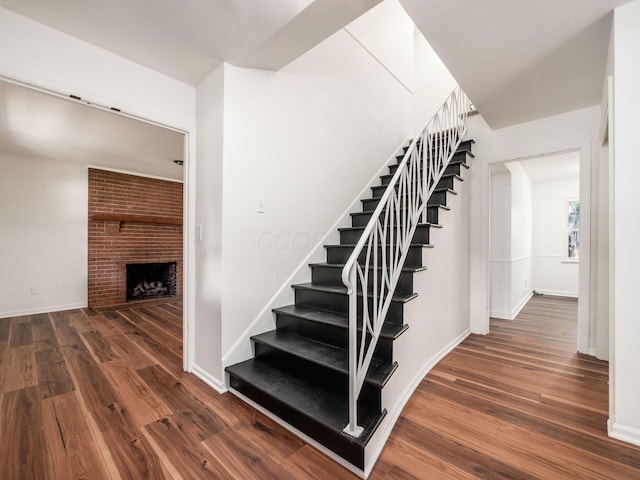 6509 Evening St, Worthington, OH 43085 - staircase with wood finished floors and a fireplace