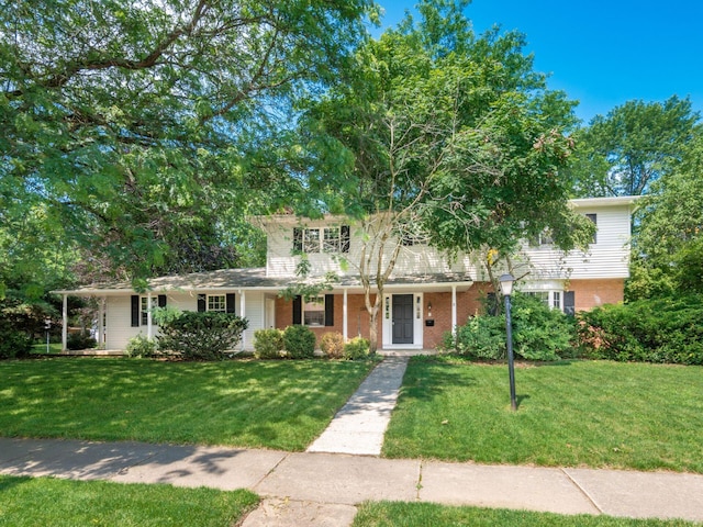 6509 Evening St, Worthington, OH 43085 - traditional-style house featuring a front lawn, brick siding, and covered porch