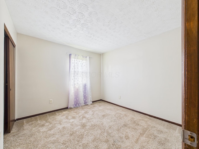 6343 Birchview Dr S Unit 6343-6345, Reynoldsburg, OH 43068 - unfurnished bedroom featuring carpet, a textured ceiling, and a closet