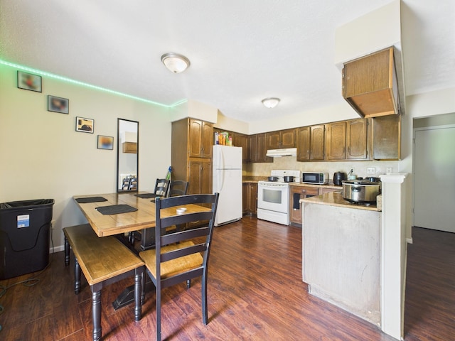 6343 Birchview Dr S Unit 6343-6345, Reynoldsburg, OH 43068 - kitchen with white appliances, light countertops, dark wood-style floors, and under cabinet range hood
