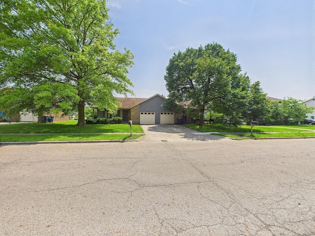 6343 Birchview Dr S Unit 6343-6345, Reynoldsburg, OH 43068 - obstructed view of property with an attached garage, concrete driveway, and a front lawn