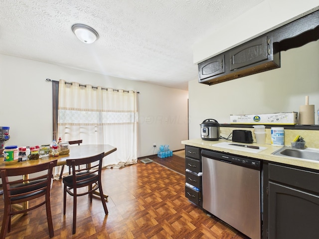 6343 Birchview Dr S Unit 6343-6345, Reynoldsburg, OH 43068 - kitchen with stainless steel dishwasher, light countertops, a textured ceiling, and dark cabinetry