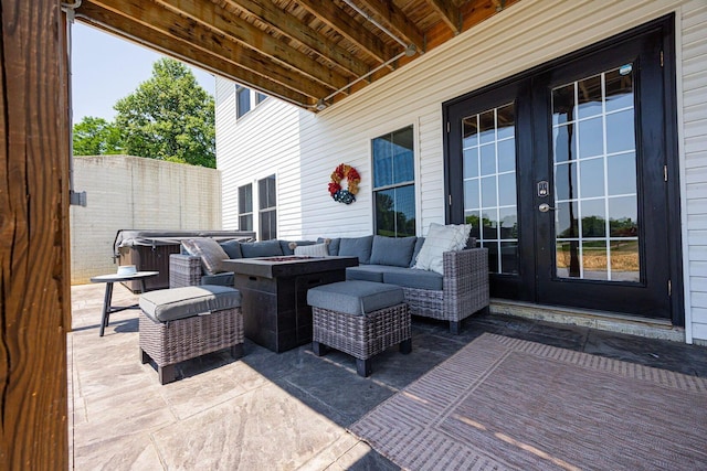 1526 Crosley Rd, Granville, OH 43023 - view of patio / terrace with french doors, a hot tub, and an outdoor living space with a fire pit