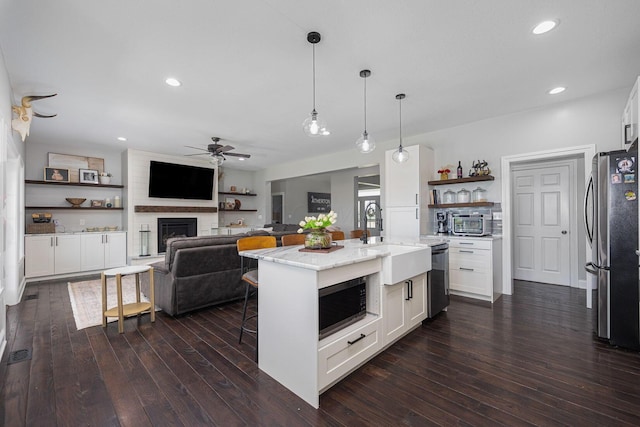 1526 Crosley Rd, Granville, OH 43023 - kitchen featuring stainless steel appliances, ceiling fan, white cabinetry, open shelves, and light stone countertops