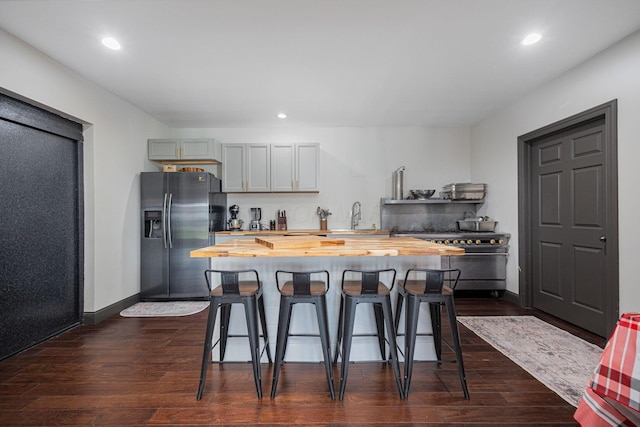 1526 Crosley Rd, Granville, OH 43023 - kitchen featuring wood counters, stainless steel appliances, a kitchen bar, dark wood-style floors, and recessed lighting