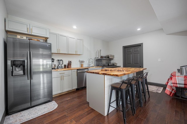 1526 Crosley Rd, Granville, OH 43023 - kitchen with stainless steel appliances, butcher block countertops, a breakfast bar area, dark wood finished floors, and recessed lighting