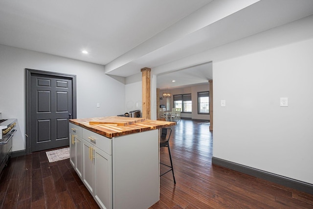 1526 Crosley Rd, Granville, OH 43023 - kitchen with butcher block counters, a kitchen bar, dark wood-type flooring, recessed lighting, and white cabinets