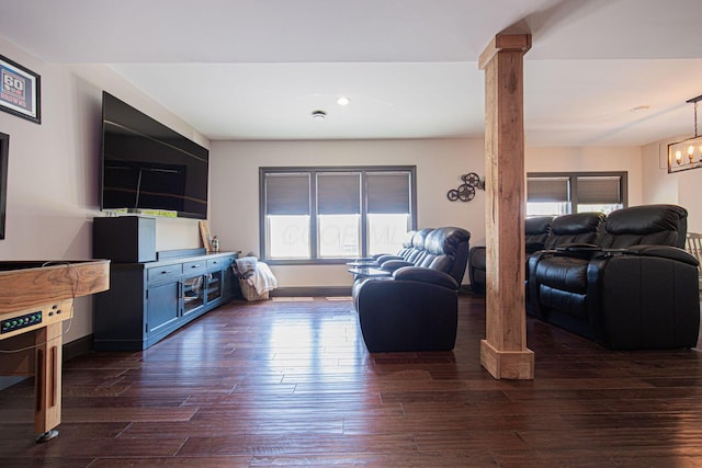 1526 Crosley Rd, Granville, OH 43023 - living room with dark wood finished floors, a chandelier, and decorative columns