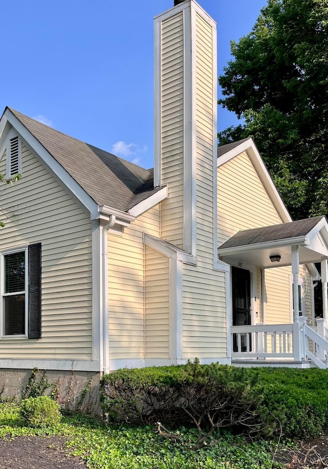 347 W 5th Ave, Columbus, OH 43201 - view of property exterior featuring a chimney and roof with shingles