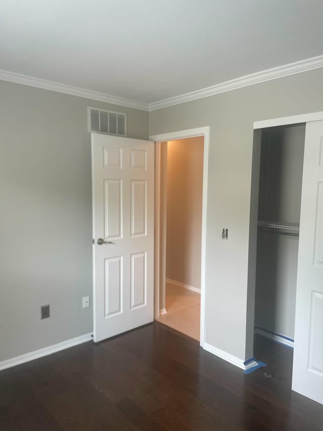 347 W 5th Ave, Columbus, OH 43201 - unfurnished bedroom featuring wood finished floors, crown molding, and a closet