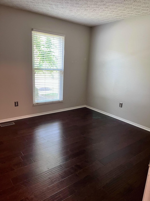 347 W 5th Ave, Columbus, OH 43201 - unfurnished room with dark wood-type flooring and a textured ceiling