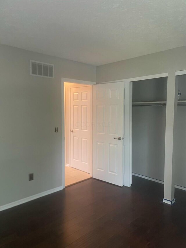 347 W 5th Ave, Columbus, OH 43201 - unfurnished bedroom with wood finished floors and two closets