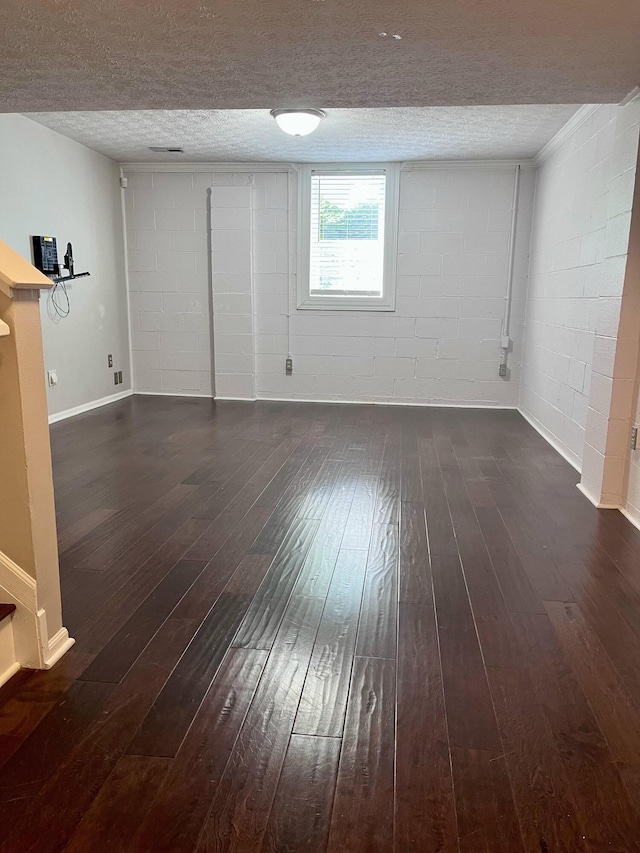 347 W 5th Ave, Columbus, OH 43201 - below grade area featuring concrete block wall, dark wood-type flooring, and a textured ceiling