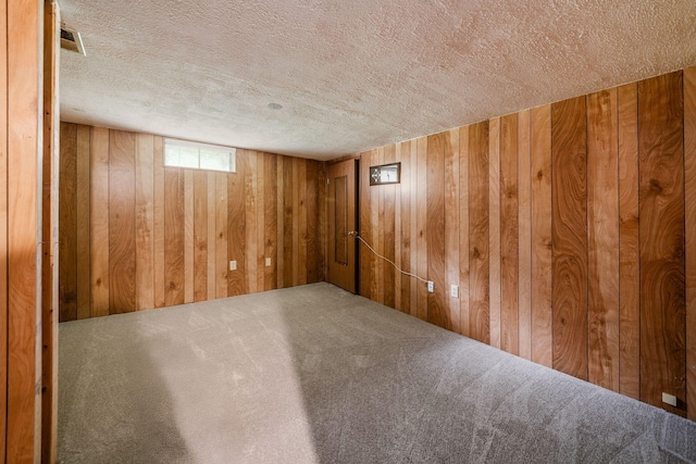 5350 Bittersweet Ct, Columbus, OH 43230 - basement featuring a textured ceiling, wooden walls, and carpet floors