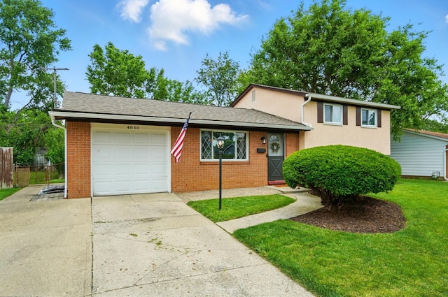 4860 Downing Dr, Columbus, OH 43232 - tri-level home featuring driveway, a garage, and brick siding