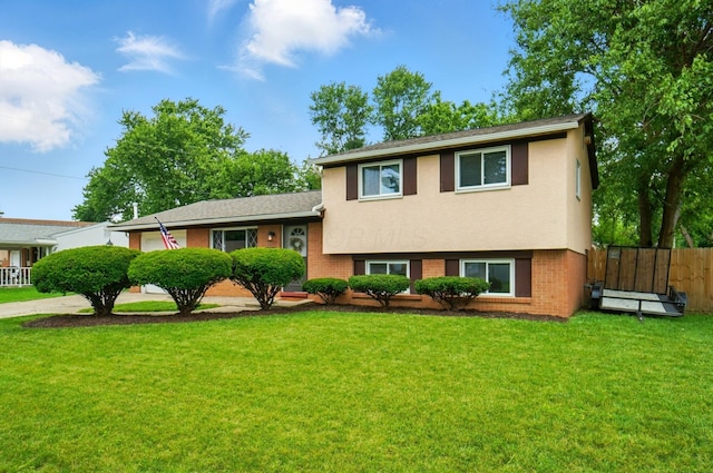 4860 Downing Dr, Columbus, OH 43232 - tri-level home featuring a garage, brick siding, and concrete driveway