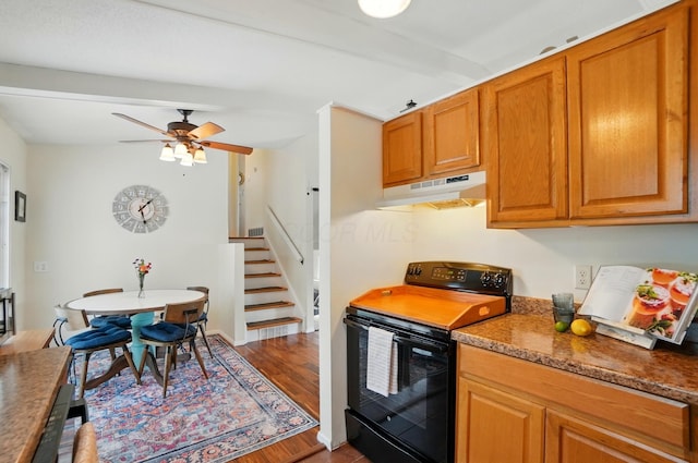 4860 Downing Dr, Columbus, OH 43232 - kitchen with black range with electric stovetop, under cabinet range hood, wood finished floors, and brown cabinets