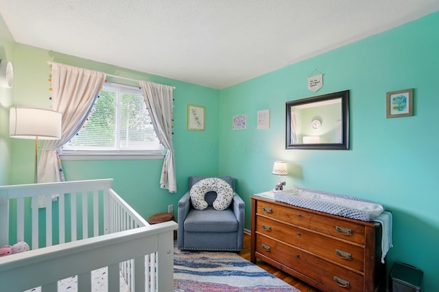4860 Downing Dr, Columbus, OH 43232 - bedroom featuring a nursery area and wood finished floors